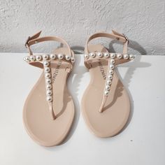 Stuart Weitzman Goldie Pearl Nude Embossed Stud Jelly Thong Sandals Women Size 5 Nwob Sandals Have Small Imperfections. See Pictures For The Best Description. *Disclaimer* An Item That Is Sent Back Must Be Returned In The Original Condition In Which Is Received To Be Eligible For A Full Refund. Elegant T-strap Sandals With Round Toe For Summer, Elegant T-strap Sandals With Flat Heel For Vacation, Elegant Ankle Strap Jelly Sandals For Summer, Elegant Open Toe Jelly Sandals, Elegant Summer Jelly Sandals With Ankle Strap, Elegant Summer Jelly Sandals With Round Toe, Elegant Jelly Sandals For Spring, Elegant T-strap Toe Post Sandals For Vacation, Elegant T-strap Sandals With Single Toe Strap For Vacation