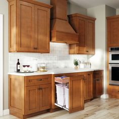 a kitchen with wooden cabinets and white counter tops