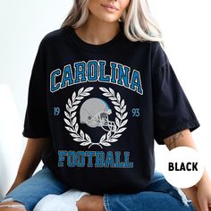 Perfect shirt for Carolina football fans this season! Ideal for any situation, a unisex heavy blend crewneck sweatshirt is pure comfort. These garments are made from polyester and cotton. This combination helps designs come out looking fresh and beautiful. The collar is ribbed knit, so it retains its shape even after washing. There are no itchy side seams on these sweaters.  .: 50% cotton, 50% polyester .: Medium-heavy fabric (8.0 oz/yd² (271.25 g/m .: Loose fit .: Sewn-in label .: Runs true to Short Sleeve Graphic Print Top For Football Season, Short Sleeve Tops With Text Print For Football Season, Blue Crew Neck T-shirt For Football Season, Carolina Panthers Shirt, Carolina Football, Heat Press Printing, Panthers Football, Football Sweatshirt, Football Gifts