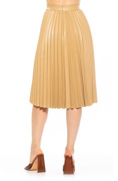 Crisp pleats define this faux-leather skirt cut to a knee length and topped with a high waist. 28" length 100% polyurethane Spot clean Imported Model stats: 5'10" height, 32" bust, 25" waist, 36" hip. Model is wearing size 2. Vegan Leather Skirt, Leather Midi Skirt, Blazer And Skirt, Exclusive Clothing, Black Leather Skirts, Faux Leather Fabric, Faux Leather Skirt, Pleated Midi Skirt, Girls Night Out