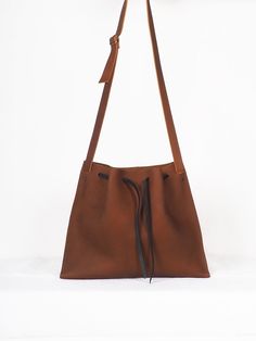 "Brown medi leather crossbody bag minimalist, Handmade leather bag, hygge leather bags, women crossbody bag, ethical bags, sustainable gifts. Cognac brown leather Origen bag Medium size. The origin collection is the simplest and purest of all my designs, the high quality of the leather and its simple lines make each bag special and unique. The medium origin leather bag is your perfect size for your everyday, traveling or going out. You can carry it over the shoulder or across the body, since the Everyday Leather Strap Crossbody Bucket Bag, Minimalist Leather Backpack, Minimalist Crossbody Hobo Bag, Minimalist Leather Hobo Bag, Minimalist Satchel With Leather Handles, Minimalist Soft Leather Crossbody Bucket Bag, Minimalist Hobo Bag With Leather Handles, Minimalist Leather Shoulder Bucket Bag, Minimalist Leather Crossbody Bucket Bag