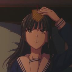 a girl with long black hair holding a waffle over her head