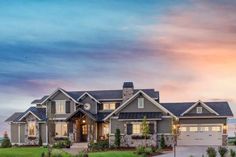 a large house with lots of windows in the front and side of it at dusk