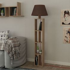 a living room with bookshelf, lamp and pictures on the wall