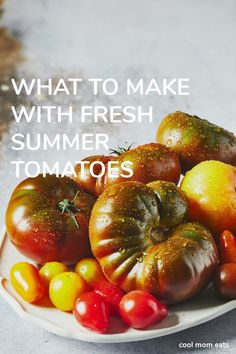 a white plate topped with lots of different types of tomatoes