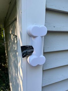 a white door handle on the side of a house