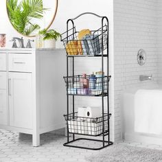 a bathroom with a white bath tub and black shelving unit next to a sink