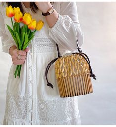 Unlock your inner elegance with the Elena Handbags Summer Bamboo Bucket Shoulder Purse. Expertly hand-woven from quality bamboo, this luxury Bucket Bag is the perfect accessory for any stylish occasion, from the office to a formal event. With its timeless design, it's sure to become your new favorite. Enjoy maximum convenience and beautiful aesthetics with this exquisite bag. Size: 18cm tall x 15cm wide (7in x 6in) Designer Style ID: 8476 Women's Bamboo Bucket Bag, Hand Woven Bucket Bag, Fashion Elegant Bag With Bamboo Handle For Vacation, Elegant Vacation Bag With Bamboo Handle, Elegant Natural Bucket Bag With Bamboo Handle, Elegant Beige Straw Bag With Bamboo Handle, Elegant Vacation Bucket Bag With Bamboo Handle, Elegant Brown Handwoven Straw Bag, Elegant Handwoven Brown Straw Bag, Elegant Beige Bags With Open Weave, Elegant Natural Color Shoulder Bag