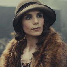 a woman wearing a fur coat and hat