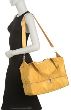 Stay stylish when traveling. The roomy interior of this Madden Girl weekend bag fits some of your favorite outfits and toiletries. - Dual top handles- Detachable, adjustable shoulder strap- Top zip closure- Exterior features slip pockets and bottom zip pocket- Interior features media pockets and zip wall pocket- Approx. 11" H x 19" W x 9.5" D- Approx. 12" handle drop, 19-30" strap drop - Imported Textile exterior and lining Modern Weekender Bag For Weekends, Trendy Gym Bag For Travel, Modern Large Capacity Travel Bag For Weekend, Weekend Tote Duffle Bag With Luggage Sleeve, Modern Weekend Bag With Luggage Sleeve, Trendy Tote Gym Bag With Zipper Closure, Weekend Tote Gym Bag With Luggage Sleeve, Versatile Weekender Bag For Weekend, Weekend Travel Bag With Double Handle