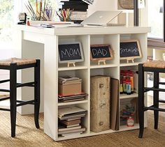 a white desk with two stools next to it