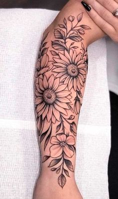 a woman's arm with flowers on it