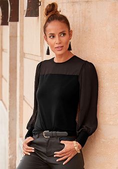 You'll be on trend in this scoop neck blouse with a sheer upper chest. Fall Blouse With Sheer Sleeves For Layering, Casual Blouse With Mesh Sleeves, Chic Black Mesh Top With Mesh Sleeves, Fall Sheer Crew Neck Blouse, Chic Blouse With Sheer Stretch Sleeves, Chic Blouse With Sheer Sleeves For Fall, Chic Stretch Blouse With Mesh Sleeves, Chic Fitted Mesh Top For Workwear, Stretch Tops With Sheer Sleeves For Work