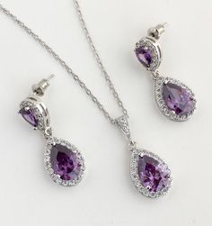 Super sparkly purple amethyst rhodium plated cubic zirconia bridal set includes : # Earrings feature a teardrop with pear cut purple amethyst cubic zirconia center surrounded by tiny round zirconia crystals. Teardrop dangles from purple cubic zirconia teardrop ear stud. Total length of the earrings is 2.9 cms. #Necklace pendant featuring a teardrop with pear cut purple amethyst cubic zirconia center surrounded by tiny round zirconia crystals and dangles from cubic zirconia bail. Length of the rh Rose Gold Bridal Jewelry, Rose Gold Bridal Earrings, Purple Bridesmaid, Pearl Bridal Jewelry, Bridal Jewelry Set, Gold Bridal Earrings, Bridesmaid Gifts Jewelry, Crystal Jewelry Sets, Rose Gold Crystal