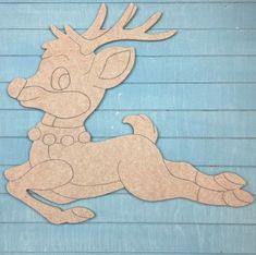 a wooden cutout of a deer laying down