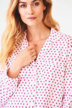 You sleep better in cute pajamas — it's science. The Perlita Lounge Dress is a super soft cotton nightshirt with a button front and front pocket. The pink heart print adds a fanciful touch to a classic sleep style. Button Front Closure Functional Breast Pocket Piping Detail Materials and Care 100% Long-Staple Premium Cotton Machine Wash Cold, With Like Colors Do Not Bleach, Tumble Dry Low (Line Dry Recommended) Imported Measurement Information Model Wears Size Small Size S Length: 34.5" (from Sh Cotton Sleepwear With Pockets For Sleepovers, Printed Long Sleeve Sleepwear, Pink Sleepwear With Pockets For Loungewear, Spring Sleepwear With Pockets, Spring Sleepwear With Pockets For Bedtime, Printed Long Sleeve Sleepwear For Sleepover, Printed Relaxed Fit Sleepwear For Sleepover, Printed Relaxed Fit Sleepwear, Relaxed Fit Sleepwear With Pockets For Bedtime