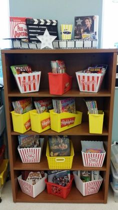 a book shelf filled with lots of books and baskets on top of it's shelves