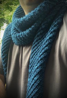 a man wearing a blue knitted scarf