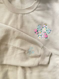 Custom  floral pet paw embroidered sweatshirt with pet name on sleeve,  EMBROIDERY DESCRIPTION : -Paw floral Embroidery is pocket placement, *Choose your sleeve  placement in personalization option: left or right sleeve? inner sleeve, outter sleeve, center of sleeve?  with added heart ! ( if not chosen your name will be embroidered on right center of sleeve )!  *please be as specific as possible so I can place your embroidery where you want it ! any questions please ask   *THREAD COLOR FOR SLEEV Cute Cream Cotton Sweatshirt, Cute Cotton Sweatshirt With Custom Embroidery, Cute Embroidered Sweatshirt Gift, Long Sleeve Tops With Custom Embroidery For Everyday, Customizable Cute Cotton Sweatshirt, Cute Cotton Everyday Sweatshirt, Cute Cotton Sweatshirt For Everyday, Cute Everyday Cotton Sweatshirt, Spring Cotton Sweatshirt Gift