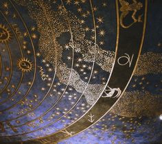 the ceiling is decorated with gold stars and zodiacs on it's blue paint