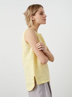 "Linen tank top with a mixed hem -- a top that will fit any outfit but won't go unnoticed. Offered in medium-weight and exclusive linen. If you're interested in light-weight option, you will find another BRAVO listing in our TOPS section. STYLE DETAILS * Loose fit * Longer at the back * Hem: straight at the front, curved at the back * Back pleat with a button * Sleeveless * French seams inside * Made from medium-weight and exclusive linen SIZES & COLORS IN THE PICTURES * Model 1 is wearing size Summer Linen Tops With Scoop Neck, Scoop Neck Linen Top For Summer, Summer Linen Top With Scoop Neck, Fitted Sleeveless Linen Blouse, White Linen Sleeveless Camisole, Beige Linen Sleeveless Tank Top, Sleeveless Linen Tank Top With Button Closure, Chic Linen V-neck Tank Top, Planet Clothing