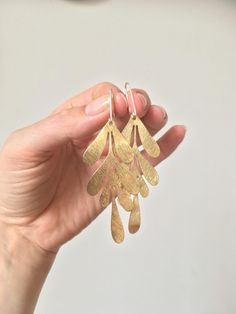 These are some lovely modern leaf earrings, the hooks are made out of sterling silver, the leafs are brass. The dangle earrings sort of remind me of the leafs Matisse painted. These hook earrings will go well with more minimal outfits. The total length of the large leaf is around 6cm and the total piece is around 8 centimetres (about 2.4 and 3.2 inches). The Medium sized leaf is about 4.5cm totalling at 6cm with the hook (1.8 and 2.4 inches). The smallest leaf is about 3.5cm long, so the total e Affordable Statement Leaf Earrings, Chunky Gold Jewelry, Easter Jewelry, Gold Jewelry Gift, Long Gold Earrings, Earrings Christmas, Festival Jewelry, Casting Jewelry, Art Deco Earrings