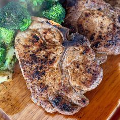 some meat and broccoli on a cutting board