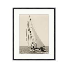 a black and white photo of a sailboat in the ocean