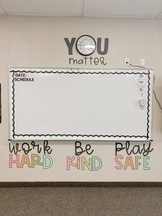 a bulletin board with words written on it in an office cubicle area that says you matter