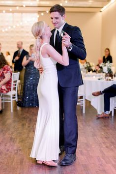 a bride and groom dance at their wedding reception