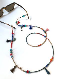 Unisex Bohemian Glasses Chain,Handmade Ethnic Sunglasses Cord,Key Charm Beaded Eye Glass Holder,Tussel Mask Chain,Gift for Her,Long Necklace If you are tired of playing hide and seek with your glasses and masks, there is a colorful news for you! Thanks to our handmade eyeglass straps, which make it almost impossible to lose glasses and give life to boring frames, you can wear your glasses comfortably by hanging them on your neck when not wearing them. It completes your full BOHO chic look! You c Adjustable Multicolor Glasses Chains For Festivals, Adjustable Tassel Jewelry For The Beach, Adjustable Tassel Jewelry For Beach, Bohemian Multicolor Glasses Chains For Festival, Multicolor Bohemian Glasses Chains For Festivals, Bohemian Multicolor Glasses Chains For Summer, Multicolor Bohemian Glasses Chains For Summer, Multicolor Bohemian Festival Glasses Chains, Bohemian Glasses Chains For Summer Festivals