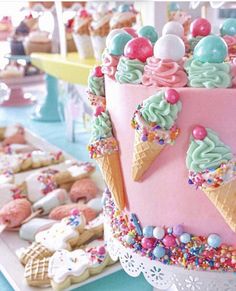 there is a pink cake with ice cream and sprinkles on it