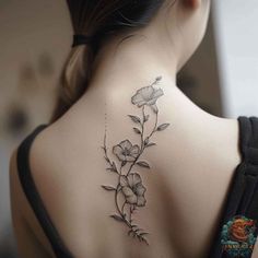 the back of a woman's neck with flowers tattoo on her left upper arm