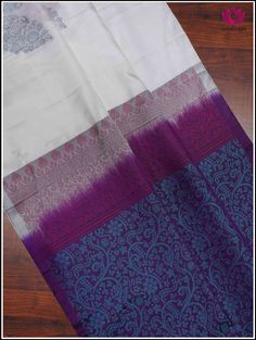 A pristine white soft silk saree featuring a tableau of butterfly patterns half adorned in royal purple threads and half in serene blue threads. The charming butterfly motifs dance across the fabric, creating a mesmerizing blend of grace and vibrancy. This borderless ethereal white saree leads to a captivating purple pallu that intricately unfolds into a tapestry of enchanting floral designs woven with delicate blue threads. This elegant combination captures the essence of sophistication, blendi White Silk Handloom Dupatta, White Tussar Silk Saree With Traditional Patterns, White Silk Handloom Traditional Wear, White Silk Dupatta With Border, White Traditional Wear With Raw Silk Patterns, White Traditional Wear With Traditional Patterns In Raw Silk, White Tussar Silk Saree For Traditional Ceremonies, White Traditional Wear With Silk Patterns, White Handloom Art Silk Dupatta