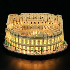 an illuminated model of a roman colossion in the shape of a building at night