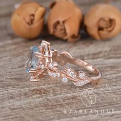 an engagement ring with a large morganite surrounded by smaller morganite stones on a wooden surface