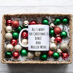 a coffee mug surrounded by christmas ornaments in a basket