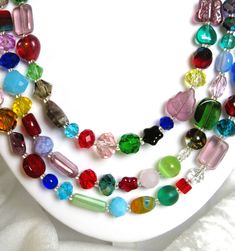 multi - colored glass beaded necklace on white surface