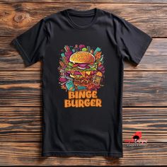 Vector Style Binge Burger T-Shirts - The Perfect Blend of Fun and Fashion! Discover our unique Vector Style Binge Burger T-Shirts, designed for those who love a blend of retro and trendy fashion. Featuring a bold fast food graphic, these shirts are perfect for burger lovers and foodies looking to make a statement. Product Details: Design: Retro-inspired vector burger graphic Material: High-quality, soft cotton for ultimate comfort Fit: Available in various sizes for a perfect fit Colors: Multipl Retro Fast Food, Burger Graphic, Casual Summer Wear, Graphic Material, Retro Mode, Lovers Gift, Retro Vibe, Summer Wear, Retro Inspired