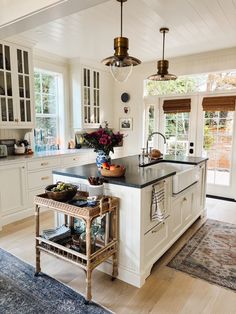 a large kitchen with an island in the middle and lots of cabinets on both sides