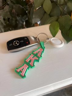 Beautiful Alpha Kappa Alpha Keychain by 4ontheyard. Show off your colors. Can be used as a Zipper tag or ornament, keychain or Luggage/book bag tag.  This listing Greek Letter Orientation is flowing downward. We also have additional listing for AKA Tags with the letters oriented to the side.  2 sizes:  3 inch and 4 inches.  Message us if you need a larger scale custom or bulk needs.  **Note Mercedes Benz keys nor car comes with this listing** :) Aka Sorority Gifts Handbags, Alpha Kappa Alpha Sorority Accessories, Aka Sorority Handbags, Alpha Kappa Alpha Sorority Accessories Pearl Numbers, Aka Pink & Green Purses, Greek Letters, Alpha Kappa Alpha, Chain Bags, Bag Tags