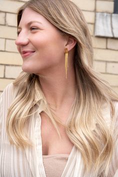 Our Tatiana Earrings, featuring a gold tassel dangle, are coming in hot, and they are going to be your new faves! They're ultra lightweight, so you can wear them all day and night without feeling weighed down – but trust us, they still pack a punch. You'll feel like you're walking down the runway every time you wear them. The playful tassel sways with every movement and adds just the right amount of flirtatious fun to your look. 18k gold-plated stainless steel Hypoallergenic Tarnish resistant Wa Trendy Gold Fringe Earrings, Trendy Gold Tassel Earrings With Fringe, Minimalist Gold Tassel Drop Earrings, Long Drop Fringe Tassel Earrings, Minimalist Tassel Earrings, Chic Tassel Earrings For Gift, Linear Tassel Dangle Earrings, Adjustable Tassel Earrings With Latkans, Earrings Square