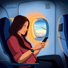 a woman sitting in an airplane looking at her cell phone and reading the text message