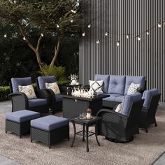 an outdoor living room with blue furniture and lights