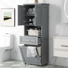 a bathroom with a gray cabinet and white toilet