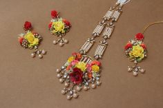 the necklace and earrings are decorated with flowers