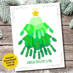 a handprint christmas card with the words instant holiday print at home on it and a pine