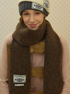 a young woman wearing a hat and scarf