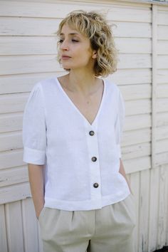 "White women V-neck blouse. Made from locally manufactured pre-washed linen fabric and is perfect for all seasons. - Handmade in our studio from 100% linen - Relaxed fit - V-neck - Buttons opening at the front side - Elbow-length puffed sleeves with cuff and button FABRIC&CARE Available in any other color of listed linen. We use medium weight and 100 % Oeko-Tex certified linen, which means that it meets ecological requirements. Hand wash or gently machine washable 30oC, hang dry recommended, Casual Linen Puff Sleeve Tops, White Linen Blouse With Puff Sleeves, Summer Linen Blouse With Puff Sleeves, Linen Blouse, Puffed Sleeves, V Neck Blouse, Linen Top, Linen Dresses, Lithuania