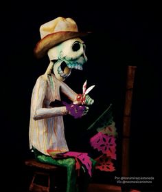 a skeleton sitting on a chair with scissors in it's hand and holding a flower